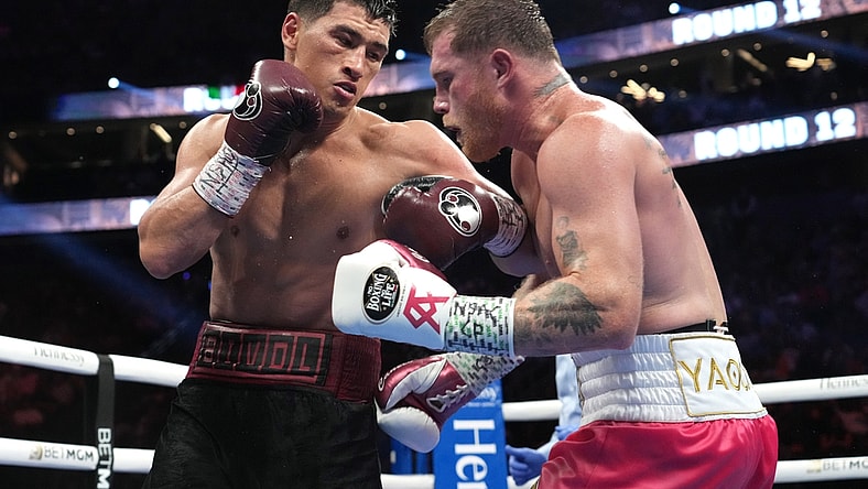 May 7, 2022; Las Vegas, Nevada, USA; Canelo Alvarez (pink trunks) and Dmitry Bivol (black trunks) box during their light heavyweight championship bout at T-Mobile Arena. Mandatory Credit: Joe Camporeale-USA TODAY Sports