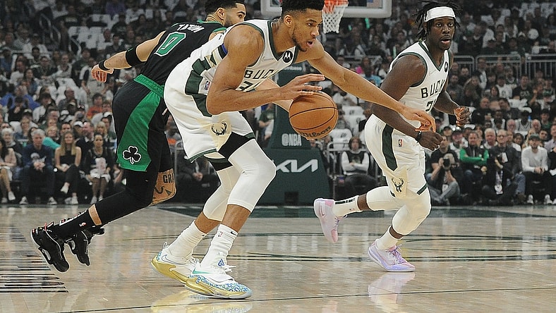 May 9, 2022; Milwaukee, Wisconsin, USA; Milwaukee Bucks forward Giannis Antetokounmpo (34) dribbles the ball against Boston Celtics forward Jayson Tatum (0) in the first half during game four of the second round for the 2022 NBA playoffs at Fiserv Forum. Mandatory Credit: Michael McLoone-USA TODAY Sports