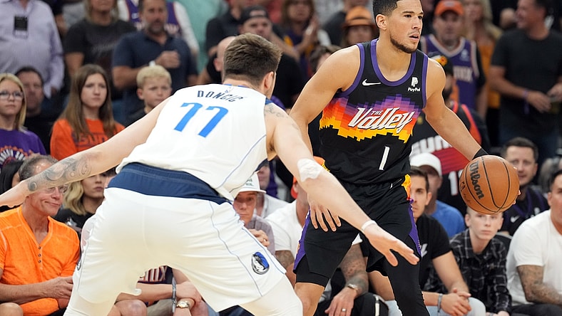 May 10, 2022; Phoenix, Arizona, USA; Phoenix Suns guard Devin Booker (1) dribbles against Dallas Mavericks guard Luka Doncic (77) during the first half of game five of the second round for the 2022 NBA playoffs at Footprint Center. Mandatory Credit: Joe Camporeale-USA TODAY Sports