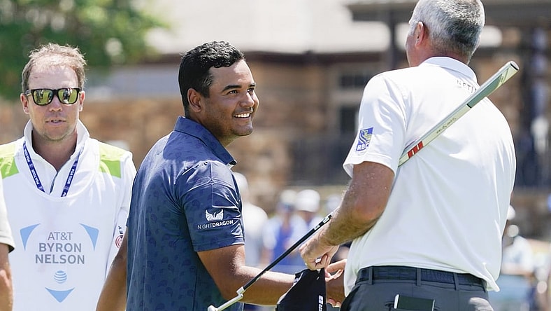May 12, 2022; McKinney, Texas, USA; Sebastian Munoz shakes the hand of playing partner Matt Kuchar on the 18th green after completing his 12-under round of 60 during the first round of the AT&T Byron Nelson golf tournament. Mandatory Credit: Raymond Carlin III-USA TODAY Sports