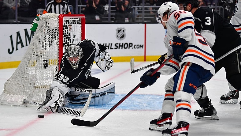 May 12, 2022; Los Angeles, California, USA; Los Angeles Kings goaltender Jonathan Quick (32) defends the goal against Edmonton Oilers right wing Kailer Yamamoto (56) during the third period in game six of the first round of the 2022 Stanley Cup Playoffs at Crypto.com Arena. Mandatory Credit: Gary A. Vasquez-USA TODAY Sports