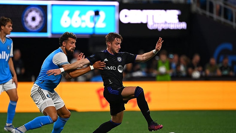 May 14, 2022; Charlotte, North Carolina, USA;  CF Montreal midfielder Djordje Mihailovic (8) with the ball as Charlotte FC defender Guzman Corujo (4) defends in the second half at Bank of America Stadium. Mandatory Credit: Bob Donnan-USA TODAY Sports