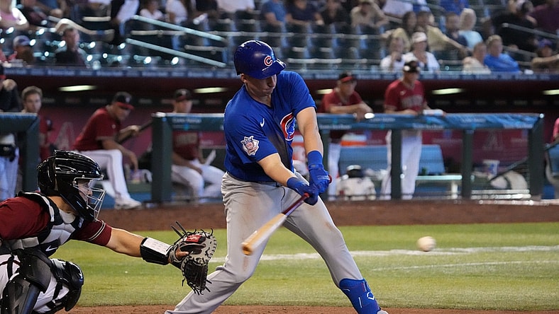 May 15, 2022; Phoenix, Arizona, USA; Chicago Cubs designated Frank Schwindel (18) hits an RBI single against the Arizona Diamondbacks during the ninth inning at Chase Field. Mandatory Credit: Joe Camporeale-USA TODAY Sports