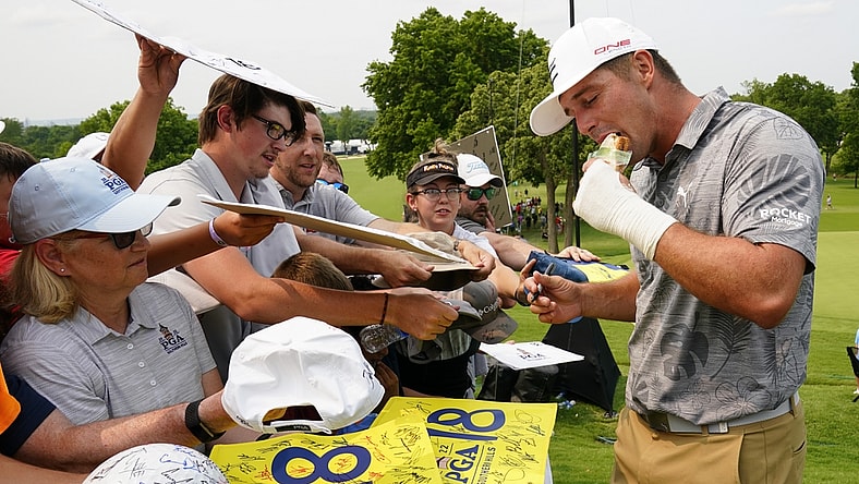 May 17, 2022; Tulsa, Oklahoma, USA; Bryson DeChambeau eats a peanut butter and grape jelly sandwich after his practice round for the PGA Championship golf tournament at Southern Hills Country Club. Mandatory Credit: Michael Madrid-USA TODAY Sports