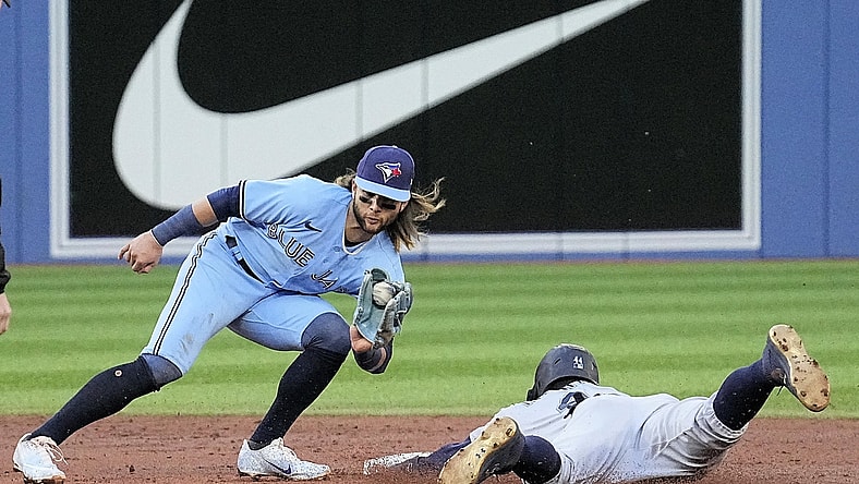 May 17, 2022; Toronto, Ontario, CAN; Seattle Mariners center fielder Julio Rodriguez (44) steals second base as the throw to Toronto Blue Jays shortstop Bo Bichette (11) arrives too late during the second inning at Rogers Centre. Mandatory Credit: John E. Sokolowski-USA TODAY Sports