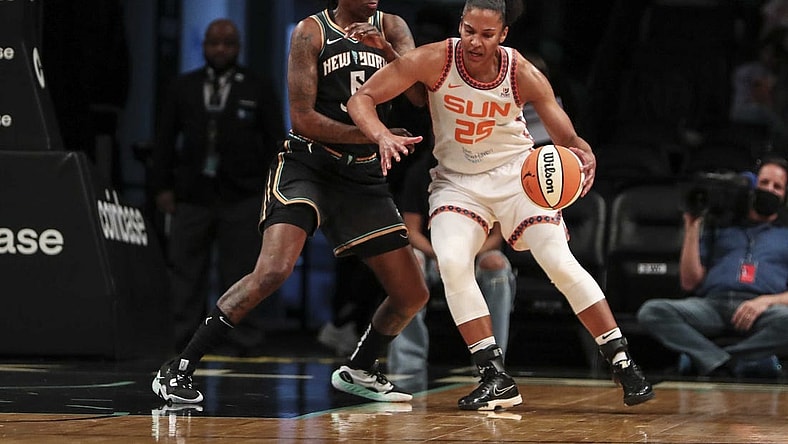 May 17, 2022; Brooklyn, New York, USA;  Connecticut Sun forward Alyssa Thomas (25) moves the ball against New York Liberty forward Natasha Howard (6) in the first quarter at Barclays Center. Mandatory Credit: Wendell Cruz-USA TODAY Sports