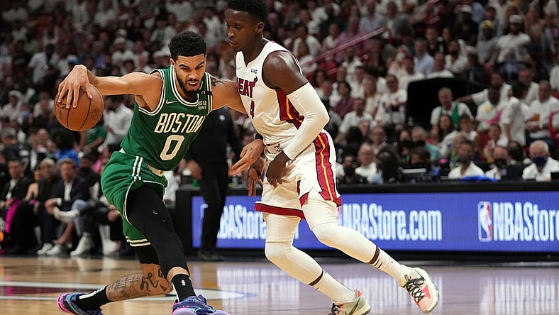 May 17, 2022; Miami, Florida, USA; Boston Celtics forward Jayson Tatum (0) dribbles around Miami Heat guard Tyler Herro (14) during the first half of game one of the 2022 eastern conference finals at FTX Arena. Mandatory Credit: Jasen Vinlove-USA TODAY Sports
