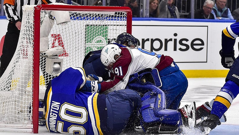 May 21, 2022; St. Louis, Missouri, USA; Colorado Avalanche center Nazem Kadri (91) collides with St. Louis Blues goaltender Jordan Binnington (50) during the first period in game three of the second round of the 2022 Stanley Cup Playoffs at Enterprise Center. Mandatory Credit: Jeff Curry-USA TODAY Sports