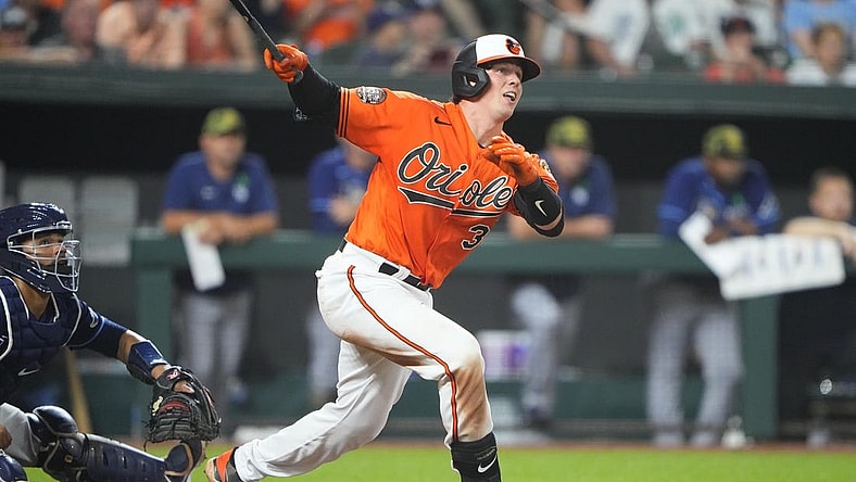 May 21, 2022; Baltimore, Maryland, USA; Baltimore Orioles catcher Adley Rutschman (35) hits a triple for his first major league hit during the seventh inning against the Tampa Bay Rays at Oriole Park at Camden Yards. Mandatory Credit: Gregory Fisher-USA TODAY Sports