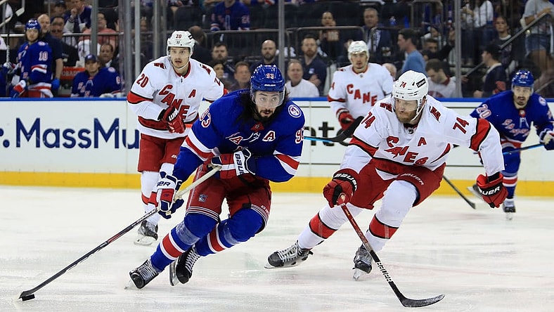 May 22, 2022; New York, New York, USA; New York Rangers center Mika Zibanejad (93) skates with the puck against Carolina Hurricanes defenseman Jaccob Slavin (74) during the second period in game three of the second round of the 2022 Stanley Cup Playoffs at Madison Square Garden. Mandatory Credit: Danny Wild-USA TODAY Sports