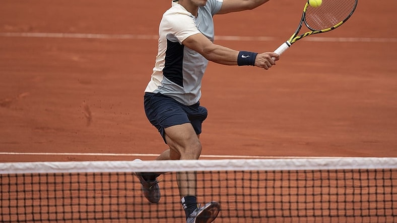 May 25, 2022; Paris, France; Carlos Alcaraz (ESP) returns a shot from Albert Ramos-Vinolas (ESP) during their match on day four of the French Open at Stade Roland-Garros. Mandatory Credit: Susan Mullane-USA TODAY Sports