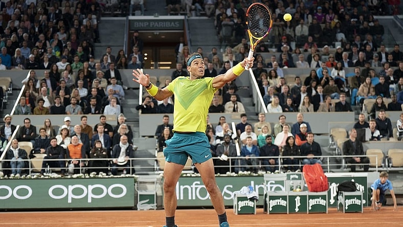 May 25, 2022; Paris, France; Rafael Nadal (ESP) returns an overhead shot from Corentin Moutet (FRA) during their match on day four of the French Open at Stade Roland-Garros. Mandatory Credit: Susan Mullane-USA TODAY Sports