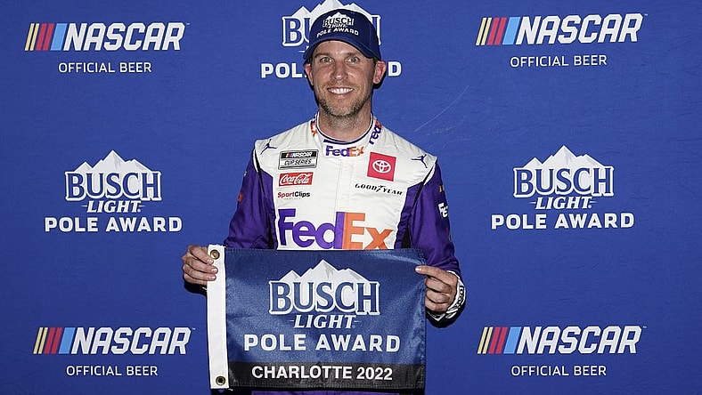 May 28, 2022; Concord, North Carolina, USA; NASCAR Cup Series driver Denny Hamlin poses for a picture after winning the pole for the Coca-Cola 600 at Charlotte Motor Speedway. Mandatory Credit: Jasen Vinlove-USA TODAY Sports