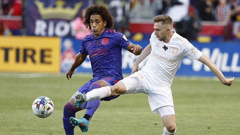 May 28, 2022; Sandy, Utah, USA; Houston Dynamo midfielder Adalberto Carrasquilla (20) and Real Salt Lake defender Andrew Brody (2) battle in the first half at Rio Tinto Stadium. Mandatory Credit: Jeffrey Swinger-USA TODAY Sports