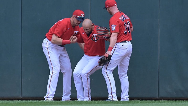May 29, 2022; Minneapolis, Minnesota, USA; Minnesota Twins left fielder Trevor Larnach (13) and right fielder Kyle Garlick (30) help center fielder Royce Lewis (23) off the ground after Lewis made a catch against the Kansas City Royals during the third inning at Target Field. Lewis would leave the game the following inning. Mandatory Credit: Jeffrey Becker-USA TODAY Sports