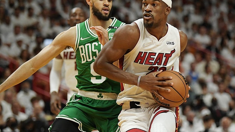 May 29, 2022; Miami, Florida, USA; Miami Heat forward Jimmy Butler (22) drives to the basket against Boston Celtics guard Derrick White (9) during the first half of game seven of the 2022 eastern conference finals at FTX Arena. Mandatory Credit: Jim Rassol-USA TODAY Sports