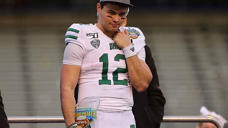 Jan 3, 2020; Boise, Idaho, USA; Ohio Bobcats quarterback Nathan Rourke (12) receives the Famous Idaho Potato Bowl most valuable player trophy after defeating the Nevada Wolf Pack at Albertsons Stadium. Ohio won 30-21. Mandatory Credit: Brian Losness-USA TODAY Sports