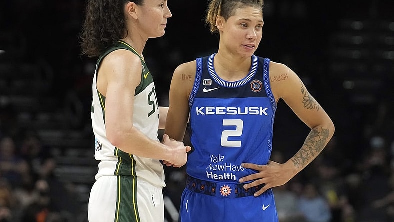 Aug 12, 2021; Phoenix, Arizona, USA; Seattle Storm guard Sue Bird (10) and Connecticut Sun guard Natisha Hiedeman (2) look on in the first half during the Inaugural WNBA Commissioners Cup Championship Game at Footprint Center. Mandatory Credit: Rick Scuteri-USA TODAY Sports