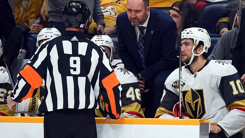 Nov 24, 2021; Nashville, Tennessee, USA; Vegas Golden Knights head coach Peter DeBoer challenges a goal call by referee Dan O'Rourke (9) during the second period against the Nashville Predators at Bridgestone Arena. Mandatory Credit: Christopher Hanewinckel-USA TODAY Sports
