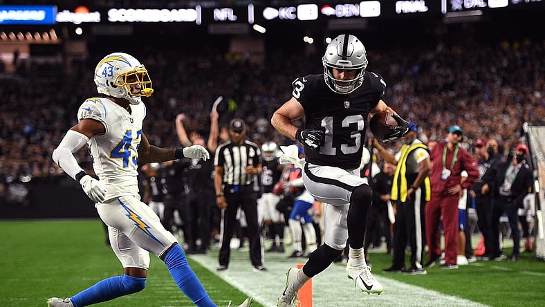 Jan 9, 2022; Paradise, Nevada, USA; Las Vegas Raiders wide receiver Hunter Renfrow (13) scores a touchdown ahead of Los Angeles Chargers cornerback Michael Davis (43) during the first quarter at Allegiant Stadium. Mandatory Credit: Orlando Ramirez-USA TODAY Sports