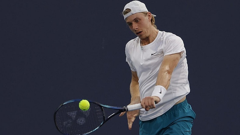 Mar 26, 2022; Miami Gardens, FL, USA; Denis Shapovalov (CAN) hits a backhand against Lloyd Harris (RSA)(not pictured) in a second round men's singles match in the Miami Open at Hard Rock Stadium. Mandatory Credit: Geoff Burke-USA TODAY Sports