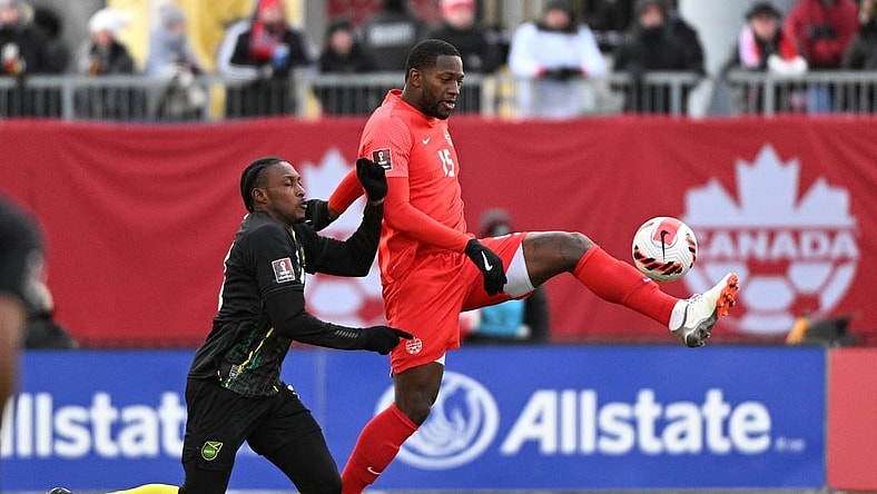 Mar 27, 2022; Toronto, Ontario, CAN;   Canada defender Doneil Henry (15) controls the ball against Jamaica midfielder Atapharoy Bygrave (18) in the second half of a FIFA World Cup qualifying soccer match at BMO Field. Mandatory Credit: Dan Hamilton-USA TODAY Sports