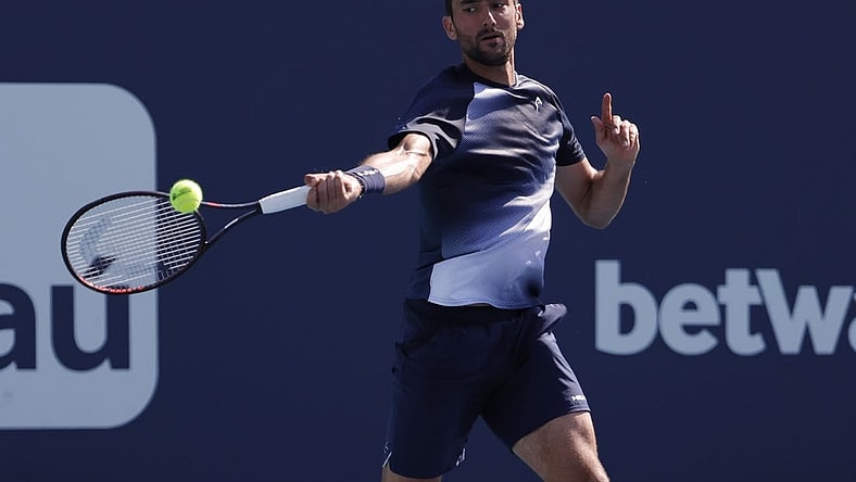 Mar 28, 2022; Miami Gardens, FL, USA; Marin Cilic (CRO) hits a forehand against Carlos Alcaraz (ESP)(not pictured) in a third round men's singles match in the Miami Open at Hard Rock Stadium. Mandatory Credit: Geoff Burke-USA TODAY Sports