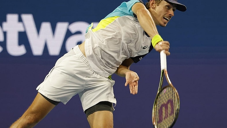 Mar 28, 2022; Miami Gardens, FL, USA; Alex de Minaur (AUS) serves against Stefanos Tsitsipas (GRE)(not pictured) in a third round men's singles match in the Miami Open at Hard Rock Stadium. Mandatory Credit: Geoff Burke-USA TODAY Sports