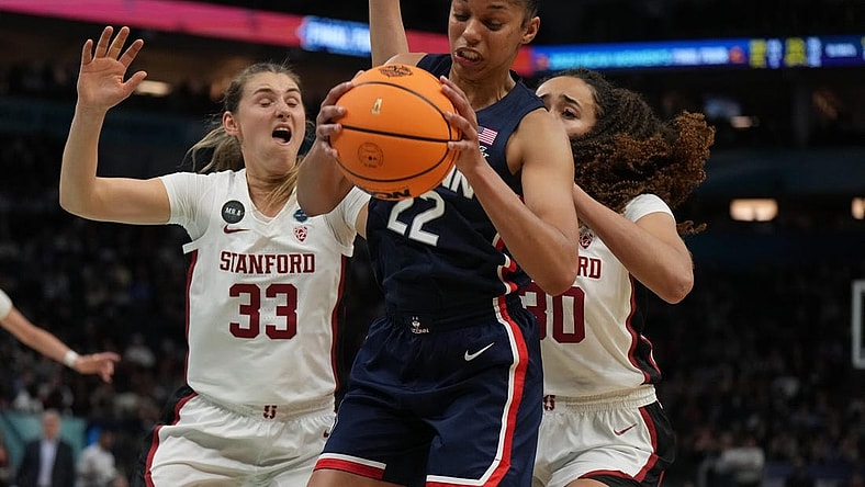Apr 1, 2022; Minneapolis, MN, USA; UConn Huskies guard Evina Westbrook (22) battles for a rebound with Stanford Cardinal guard Hannah Jump (33) and Stanford Cardinal guard Haley Jones (30) during the second half in the Final Four semifinals of the women's college basketball NCAA Tournament at Target Center. Mandatory Credit: Kirby Lee-USA TODAY Sports