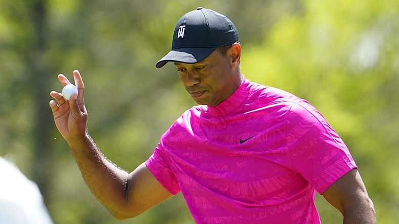 Apr 7, 2022; Augusta, Georgia, USA; Tiger Woods waves to the crowd after sinking a putt on no. 6 during the first round of The Masters golf tournament at Augusta National Golf Club. Mandatory Credit: Danielle Parhizkaran-Augusta Chronicle/USA TODAY Sports