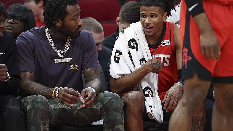 Apr 10, 2022; Houston, Texas, USA; Houston Rockets guard Jalen Green (0) talks with guard John Wall (left) during the second quarter against the Atlanta Hawks at Toyota Center. Mandatory Credit: Troy Taormina-USA TODAY Sports