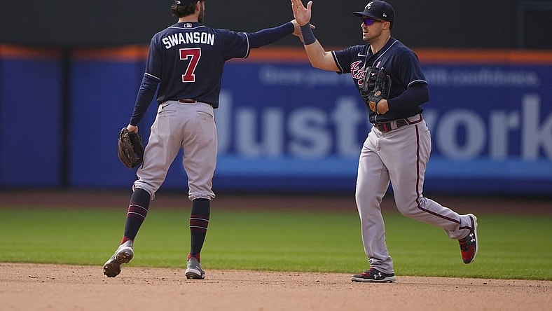 May 4, 2022; New York City, New York, USA; Atlanta Braves shortstop Dansby Swanson (7) and Atlanta Braves center fielder Adam Duvall (14) hi five to celebrate the victory after the ninth inning against the New York Mets at Citi Field. Mandatory Credit: Gregory Fisher-USA TODAY Sports