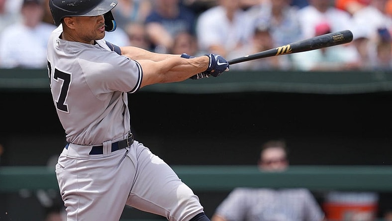 May 19, 2022; Baltimore, Maryland, USA; New York Yankees designated hitter Giancarlo Stanton (27) drives in two runs in the first inning against the Baltimore Orioles at Oriole Park at Camden Yards. Mandatory Credit: Mitch Stringer-USA TODAY Sports