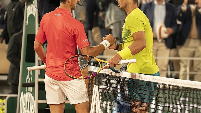 May 31, 2022; Paris, France; Rafael Nadal (ESP) at the net with Novak Djokovic (SRB) after their match on day 10 of the French Open at Stade Roland-Garros. Nadal won 6-2, 4-6, 6-2, 7-6 (4). Mandatory Credit: Susan Mullane-USA TODAY Sports