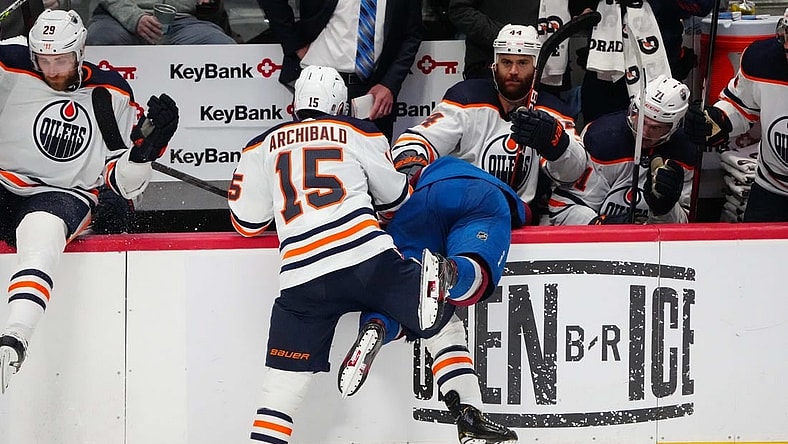 Jun 2, 2022; Denver, Colorado, USA; Edmonton Oilers right wing Zack Kassian (44) pulls the helmet off of Colorado Avalanche defenseman Bowen Byram (4) after a check by right wing Josh Archibald (15) in the third period of game two of the Western Conference Final of the 2022 Stanley Cup Playoffs at Ball Arena. Mandatory Credit: Ron Chenoy-USA TODAY Sports