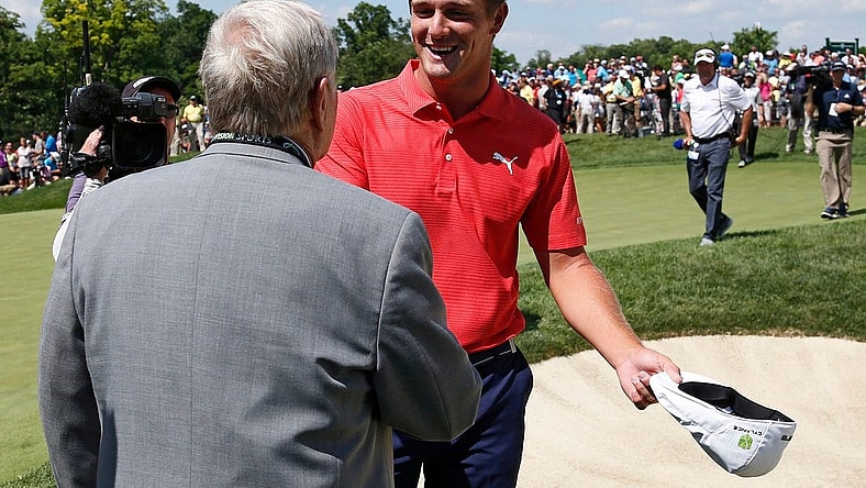 Bryson DeChambeau shakes hands with Jack Nicklaus following his playoff win in the final round of the Memorial Tournament at Muirfield Village Golf Club in Dublin, Ohio on June 3, 2018. DeChambeau won the tournament in a two-hole playoff. [Adam Cairns / Dispatch]
