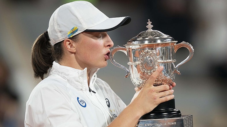 June 4, 2022; Paris, France; Iga Swiatek (POL) kisses the trophy after winning the women's singles final against Coco Gauff (USA) on day 14 of the French Open at Stade Roland-Garros. Mandatory Credit: Susan Mullane-USA TODAY Sports