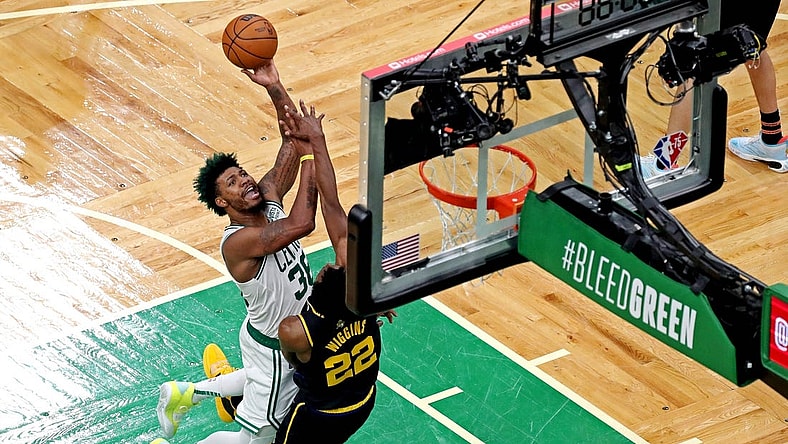 Jun 8, 2022; Boston, Massachusetts, USA; Boston Celtics guard Marcus Smart (36) shoots the ball against Golden State Warriors forward Andrew Wiggins (22) in game three of the 2022 NBA Finals at TD Garden. Mandatory Credit: Paul Rutherford-USA TODAY Sports