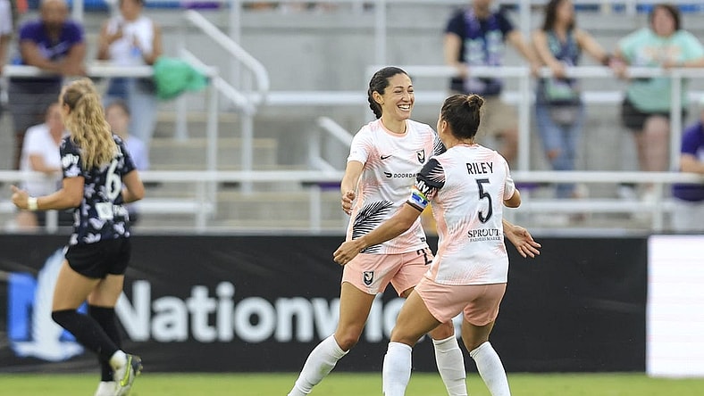 Jun 11, 2022; Louisville, Kentucky, USA;  Angel City FC defender Ali Riley (5) celebrates a goal made by Angel City FC forward Christen Press (23) against Racing Louisville FC during the second half at Lynn Family Stadium. Mandatory Credit: Aaron Doster-USA TODAY Sports