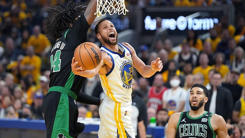 Jun 13, 2022; San Francisco, California, USA; Golden State Warriors guard Stephen Curry (30) goes to the basket while defended by Boston Celtics center Robert Williams III (44) during the first half in game five of the 2022 NBA Finals at Chase Center. Mandatory Credit: Kyle Terada-USA TODAY Sports