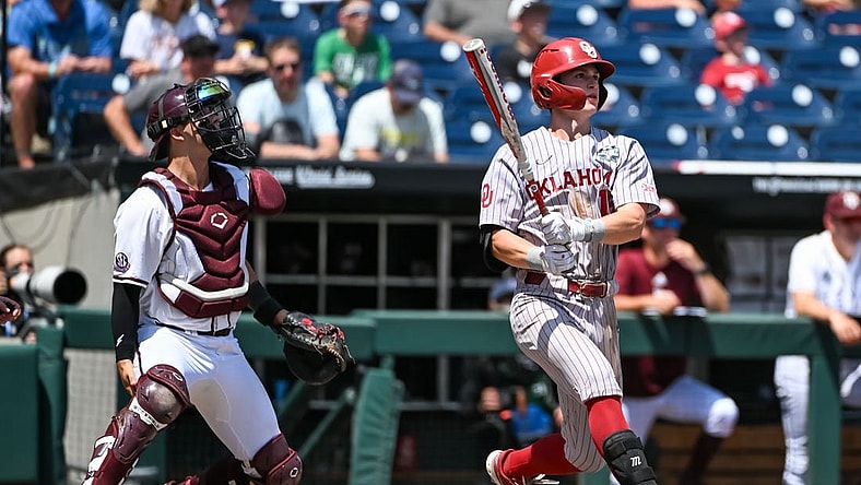 Jun 17, 2022; Omaha, NE, USA; Oklahoma Sooners second baseman Jackson Nicklaus (15) hits a grand slam home run against the Texas A&M Aggies in the fourth inning at Charles Schwab Field. Mandatory Credit: Steven Branscombe-USA TODAY Sports