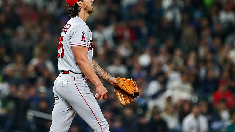 Jun 17, 2022; Seattle, Washington, USA; Los Angeles Angels starting pitcher Michael Lorenzen (25) reacts after walking in a run against the Seattle Mariners during the fourth inning at T-Mobile Park. Mandatory Credit: Lindsey Wasson-USA TODAY Sports