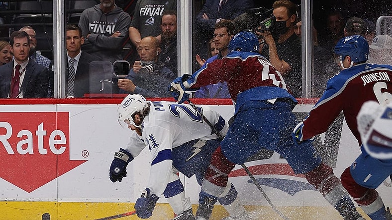Jun 18, 2022; Denver, Colorado, USA; Colorado Avalanche defenseman Josh Manson (42) hits Tampa Bay Lightning center Brayden Point (21) during the third period in game two of the 2022 Stanley Cup Final at Ball Arena. Mandatory Credit: Isaiah J. Downing-USA TODAY Sports