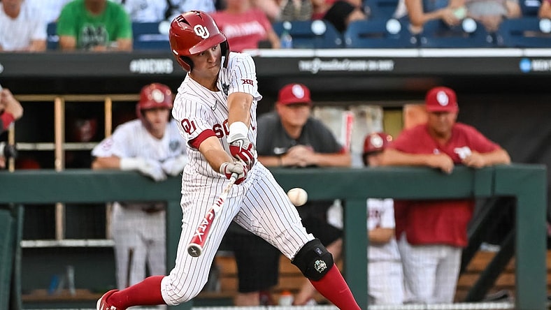 Jun 19, 2022; Omaha, NE, USA;  Oklahoma Sooners center fielder Tanner Tredaway (10) singles in a run against the Notre Dame Fighting Irish in the third inning at Charles Schwab Field. Mandatory Credit: Steven Branscombe-USA TODAY Sports