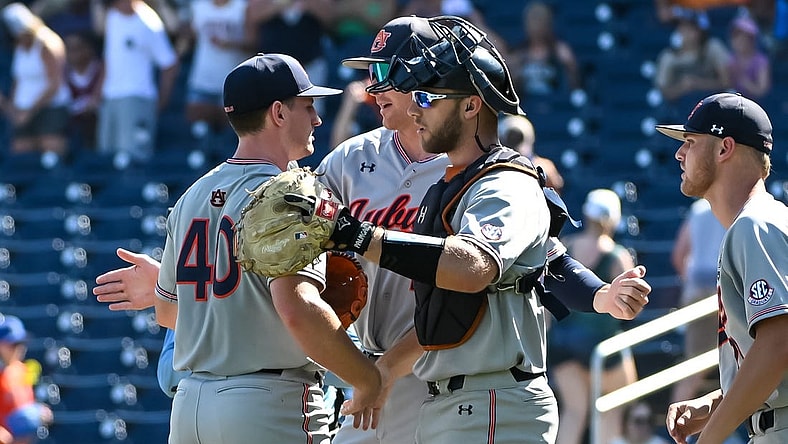 Jun 20, 2022; Omaha, NE, USA;  Auburn Tigers pitcher Blake Burkhalter (40) and catcher Nate LaRue (28) meet after the win against the Stanford Cardinal at Charles Schwab Field. Mandatory Credit: Steven Branscombe-USA TODAY Sports