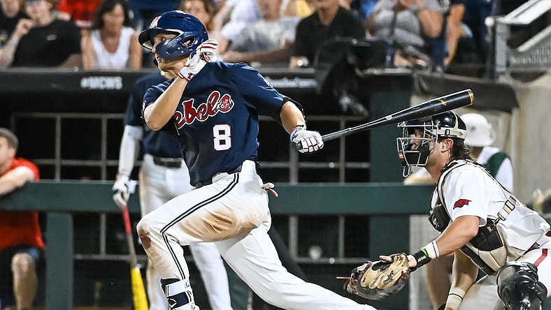 Jun 20, 2022; Omaha, NE, USA;  Ole Miss Rebels center fielder Justin Bench (8) drives in a run against the Arkansas Razorbacks in the eighth inning at Charles Schwab Field. Mandatory Credit: Steven Branscombe-USA TODAY Sports