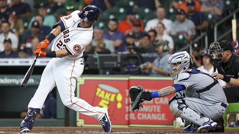 Jun 22, 2022; Houston, Texas, USA; Houston Astros designated hitter Michael Brantley (23) hits an RBI double against the New York Mets in the first inning at Minute Maid Park. Mandatory Credit: Thomas Shea-USA TODAY Sports