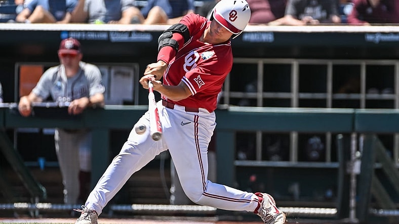 Jun 22, 2022; Omaha, NE, USA; Oklahoma Sooners catcher Jimmy Crooks (3) singles in the third inning against the Texas A&M Aggies at Charles Schwab Field. Mandatory Credit: Steven Branscombe-USA TODAY Sports