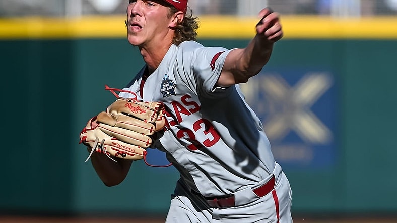 Jun 22, 2022; Omaha, NE, USA; Arkansas Razorbacks starting pitcher Hagen Smith (33) throws against the Ole Miss Rebels in the first inning at Charles Schwab Field. Mandatory Credit: Steven Branscombe-USA TODAY Sports