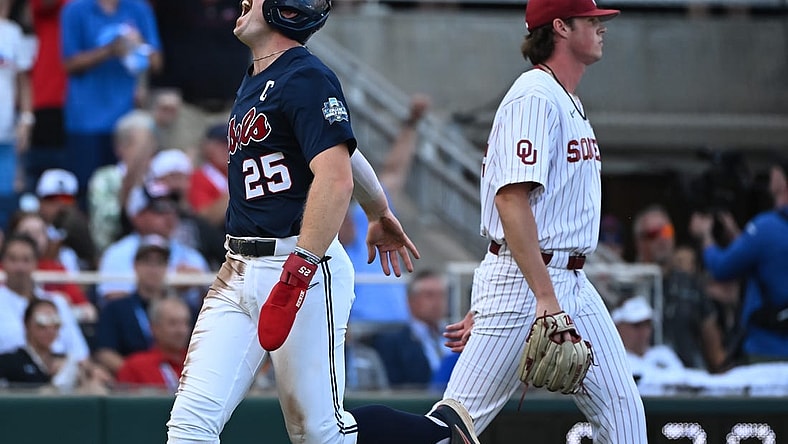 Jun 25, 2022; Omaha, NE, USA;  Ole Miss Rebels first baseman Tim Elko (25) scores against the Oklahoma Sooners during the first inning at Charles Schwab Field. Mandatory Credit: Steven Branscombe-USA TODAY Sports